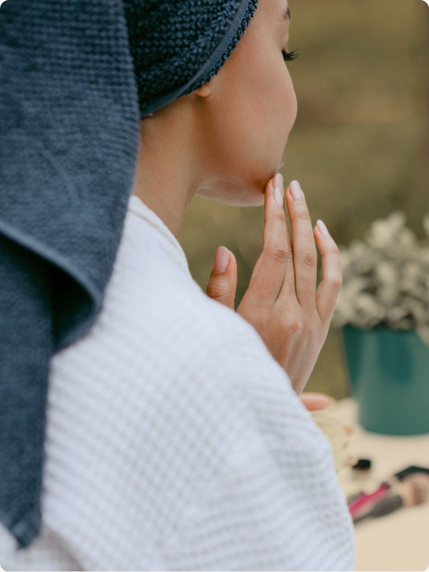 Woman on a picnic blanket applying skincare