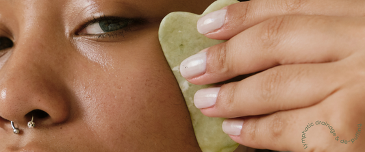 Close-up of gua sha tool used for facial lymphatic drainage and de-puffing to achieve a sculpted look