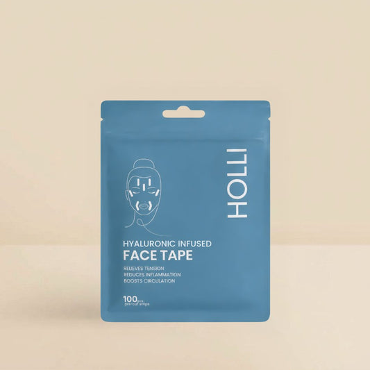 A blue stand-up pouch of HOLLI Hyaluronic Infused Face Tape on a warm beige background. The packaging features a white line drawing of a face with tape applied, alongside the brand name 'HOLLI' in white vertical text.