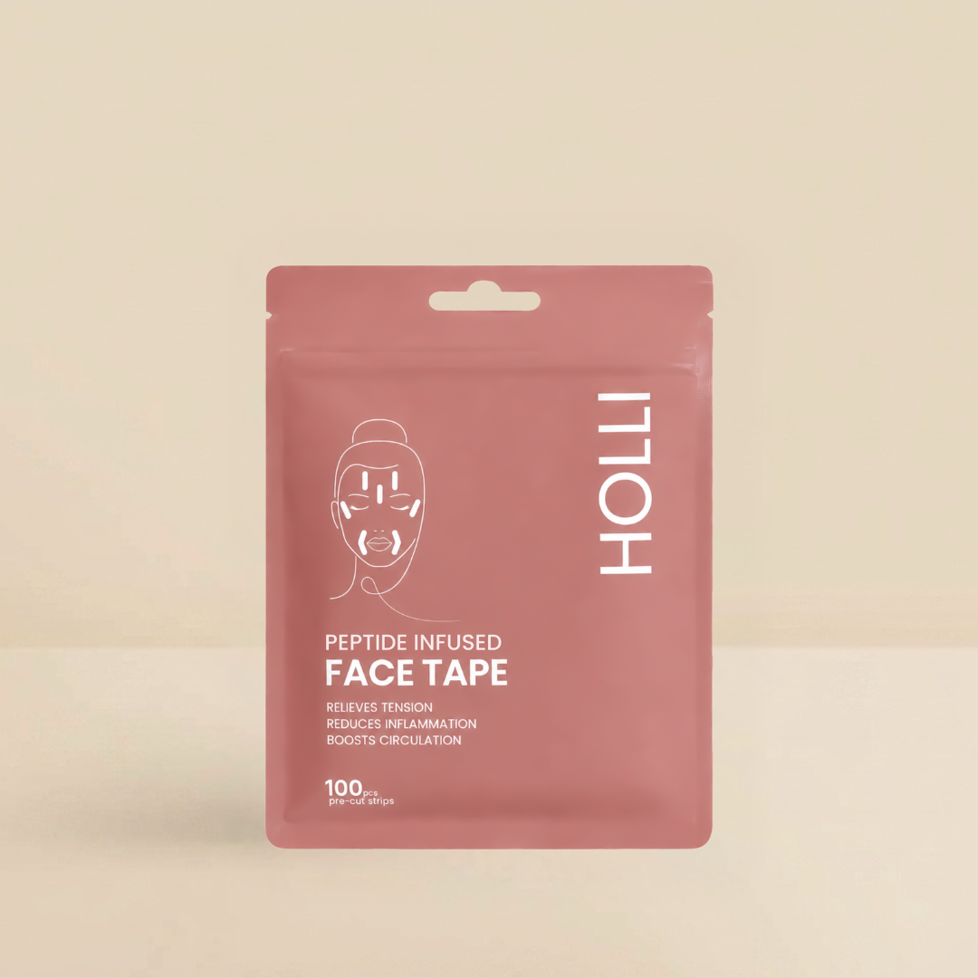 A pink stand-up pouch of HOLLI Peptide Infused Face Tape on a warm beige background. The packaging features white text and a minimalist face graphic.