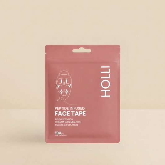 A pink stand-up pouch of HOLLI Peptide Infused Face Tape on a warm beige background. The packaging features white text and a minimalist face graphic.