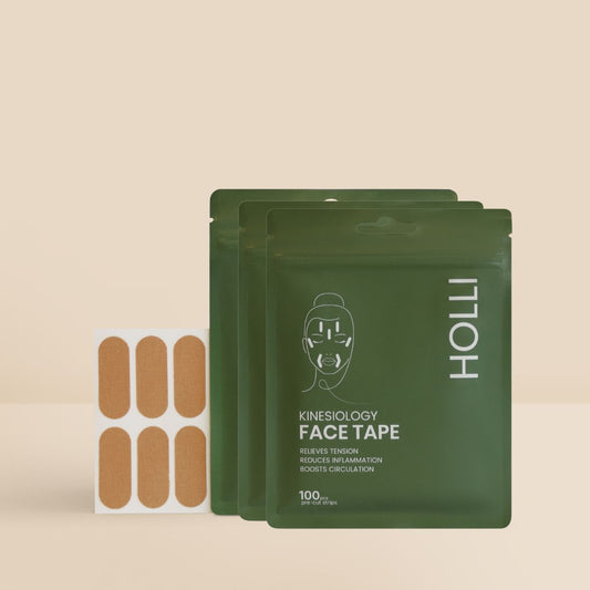 Three green packages of HOLLI  kinesiology face tape with a beige background