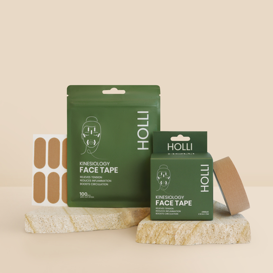 HOLLI Kinesiology Face Tape set with green packaging, a sheet of adhesive tape, and a roll of brown tape displayed on a beige background.