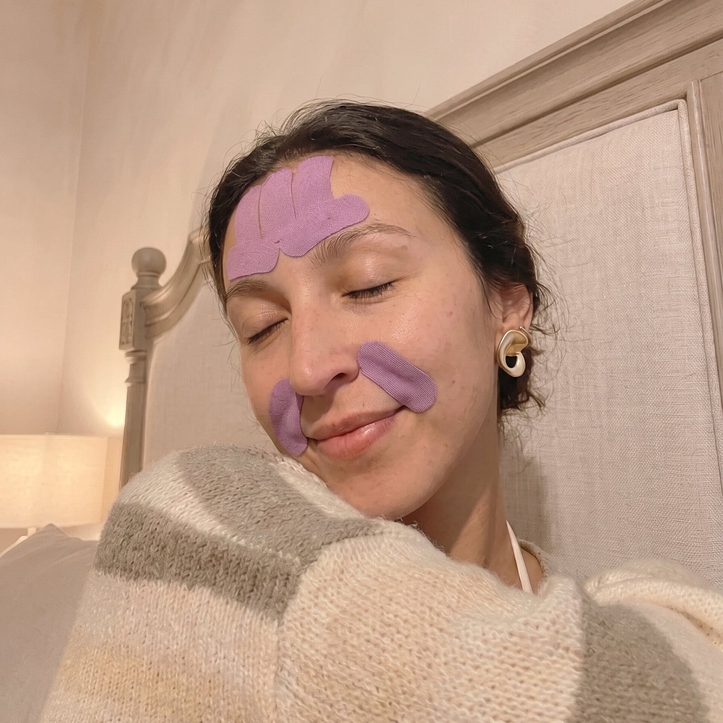Woman wearing HOLLI Peptide infused face tape on her skin
