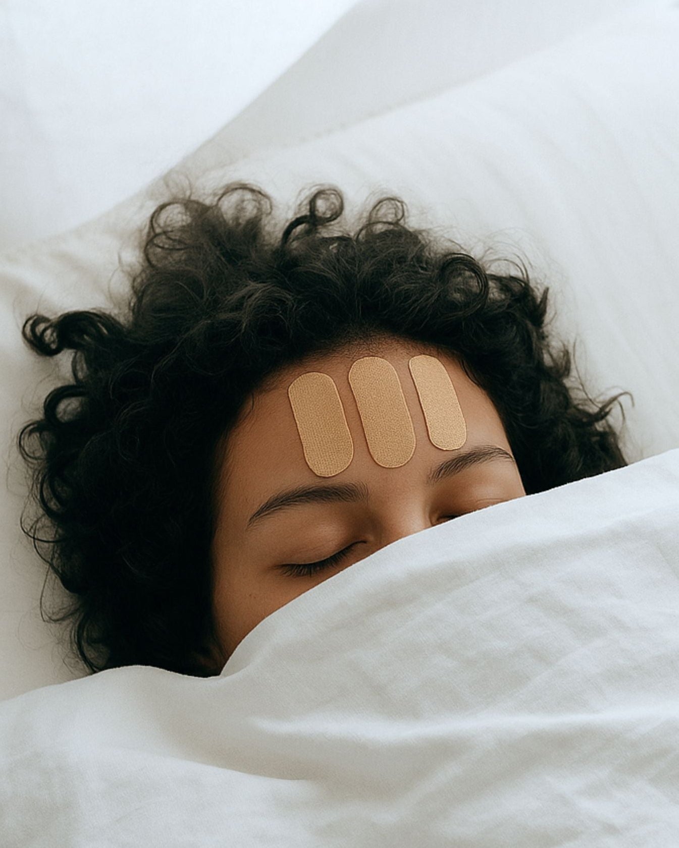 Woman resting peacefully in bed as part of overnight face taping ritual before gently removing tape in the morning